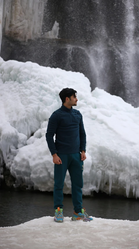 the man standing in front of a waterfall