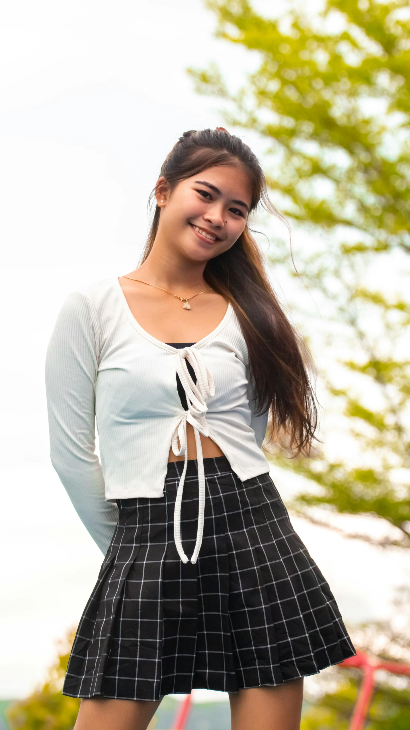 young woman posing for the camera with long brown hair