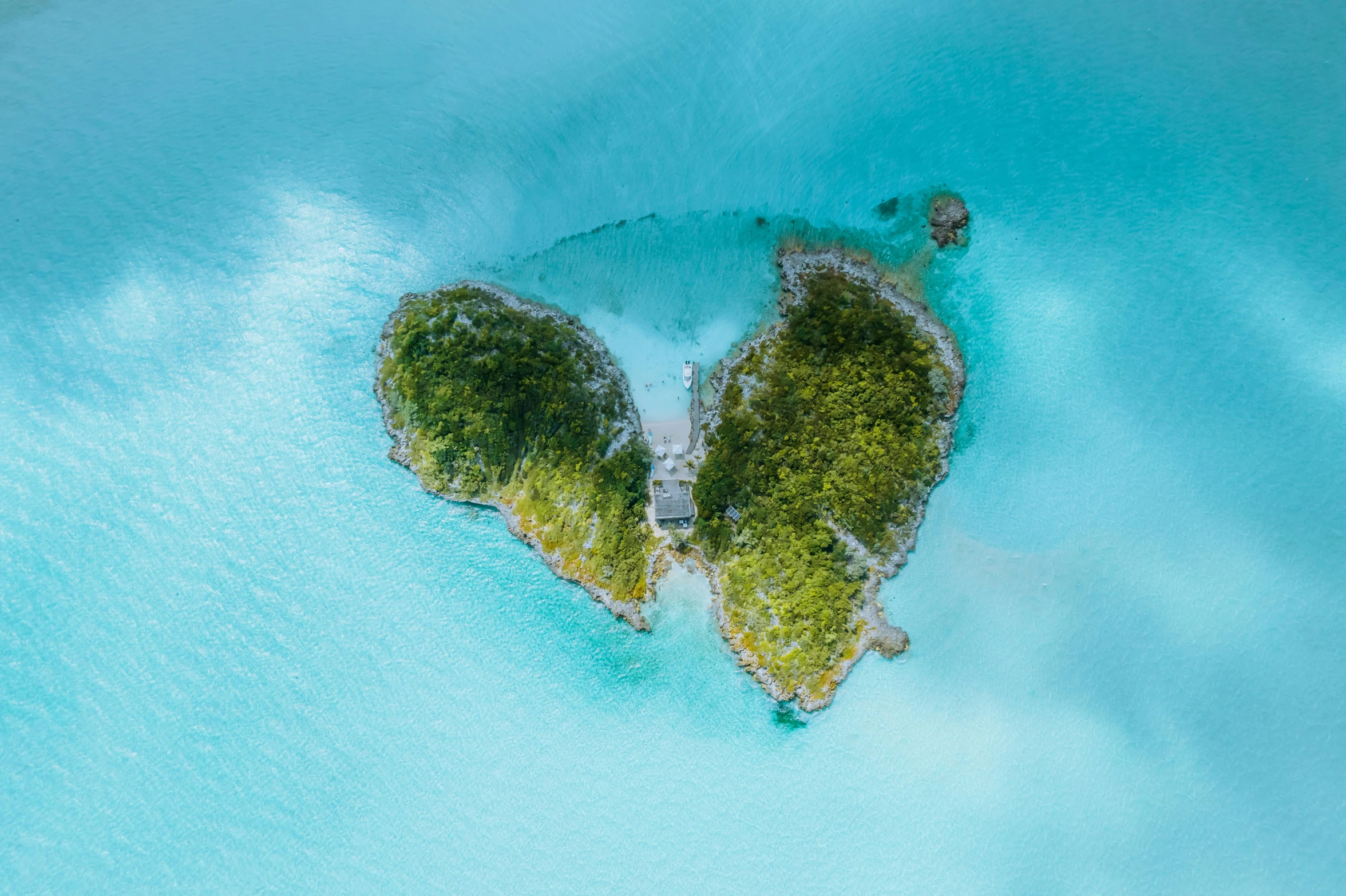 two rocks in the middle of water shaped like two heart shapes