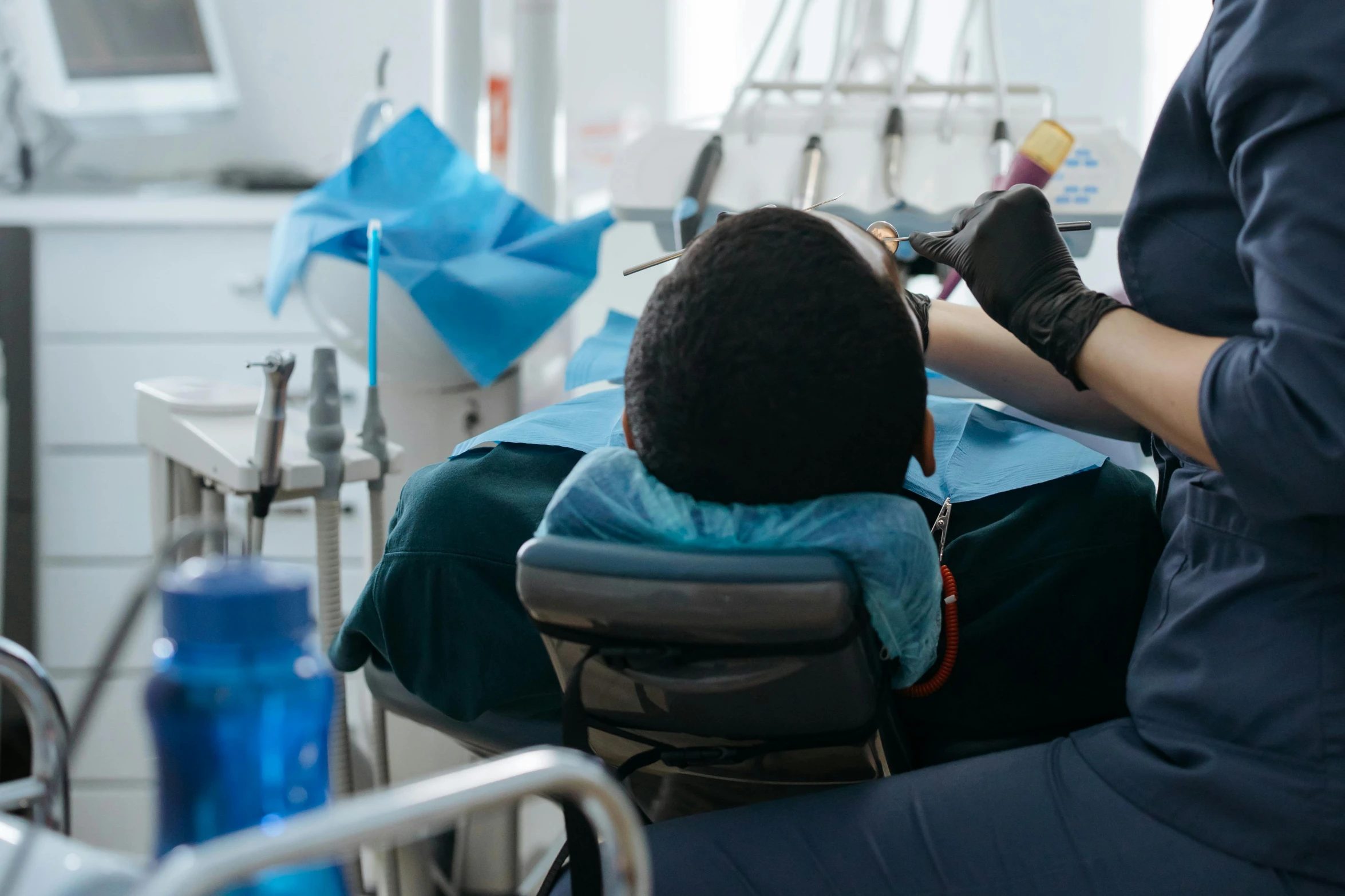 a person in a chair operating on a toothbrush