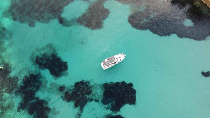 an aerial s of a boat off a beach