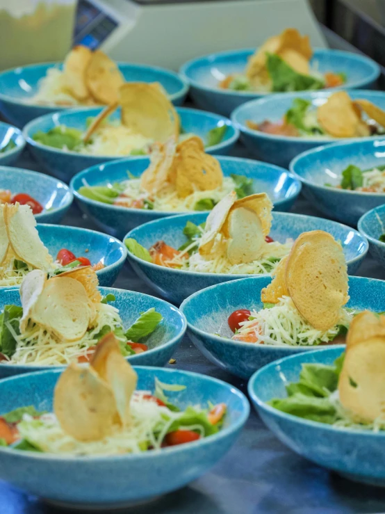 a close up of many bowls filled with food