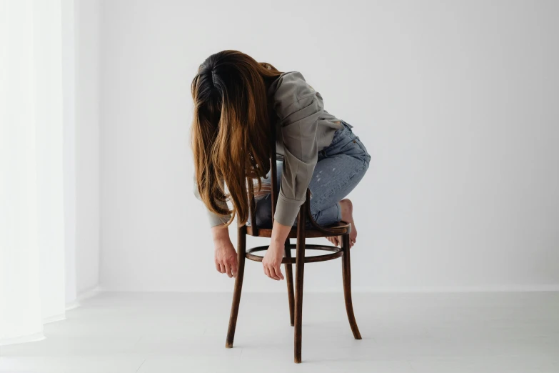 a person sitting on a chair with their back to the camera