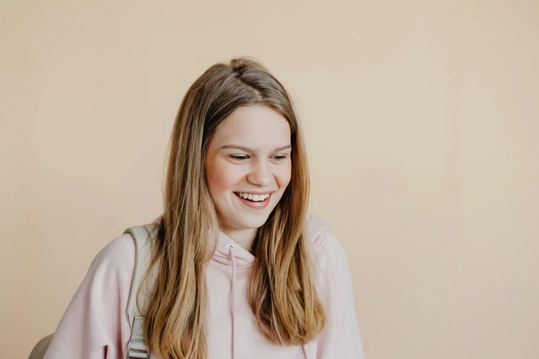 smiling woman with backpack and backpack on her shoulders