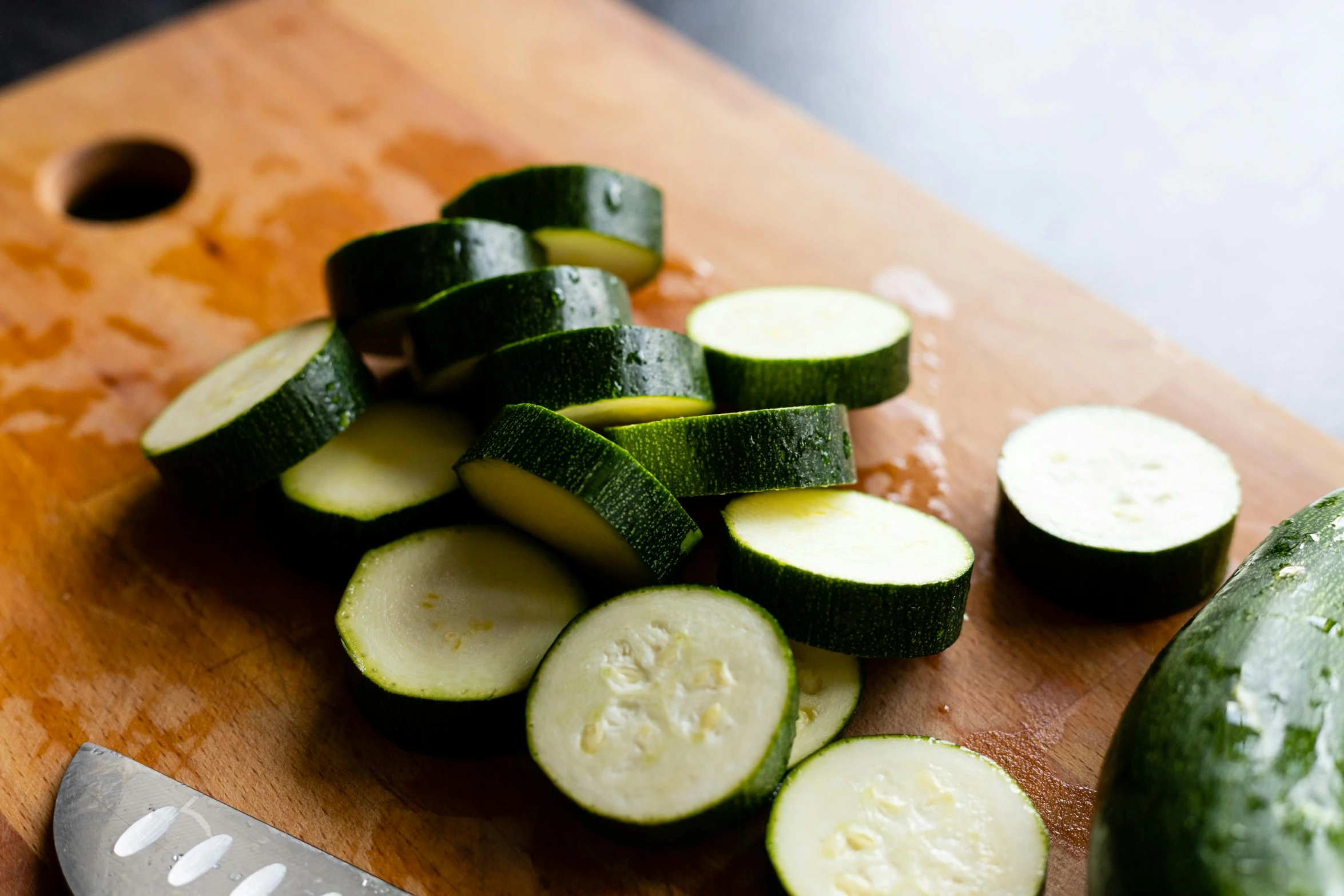 the cucumbers are sliced up on the  board