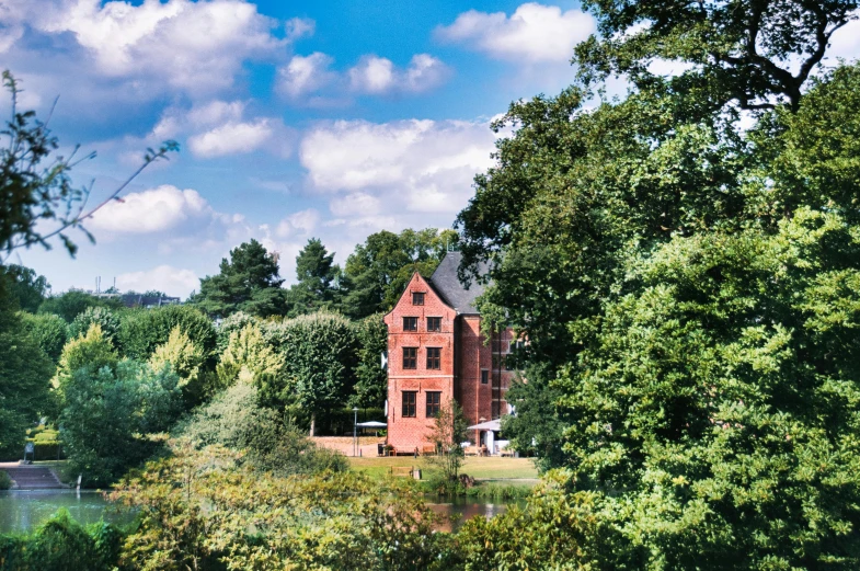 an old house is surrounded by trees and water