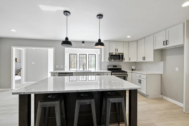 an open kitchen is shown with black bar stools