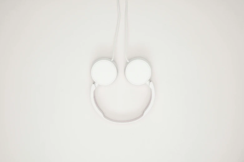 white headphones are hanging on a hook