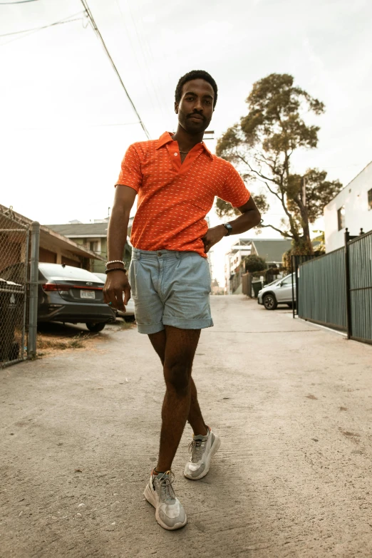 a man is posing with his arms behind his back