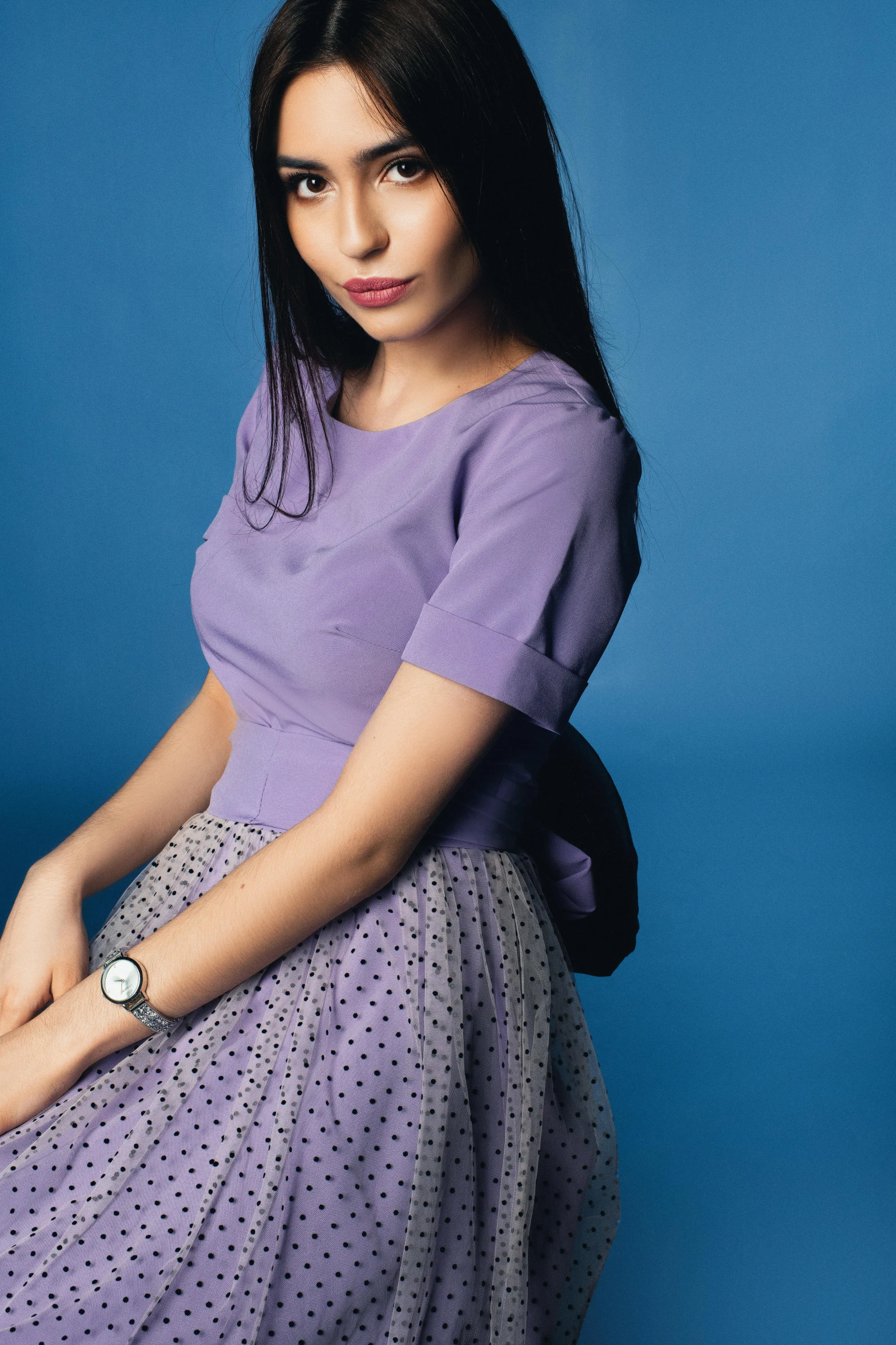 a beautiful young lady is wearing a purple dress