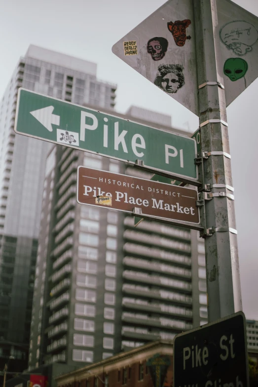 multiple street signs on top of a pole