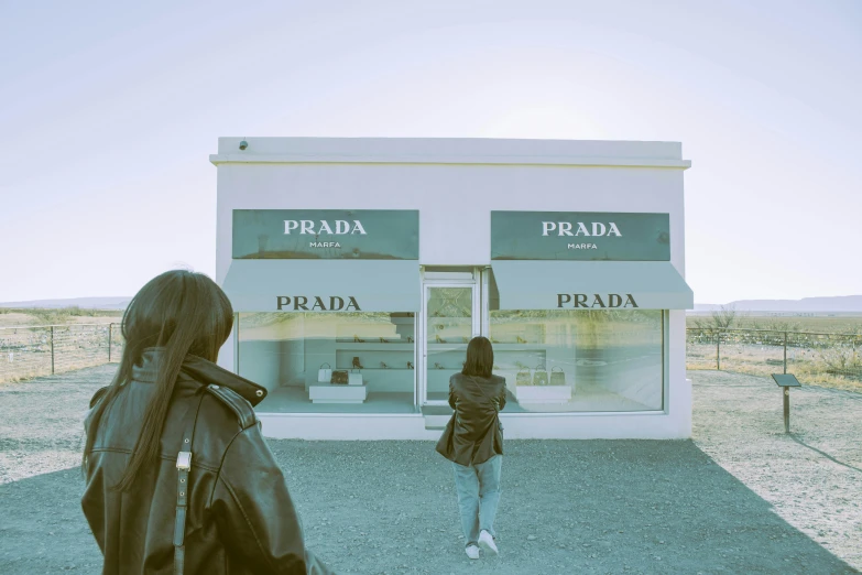 a woman walking by a store with a window