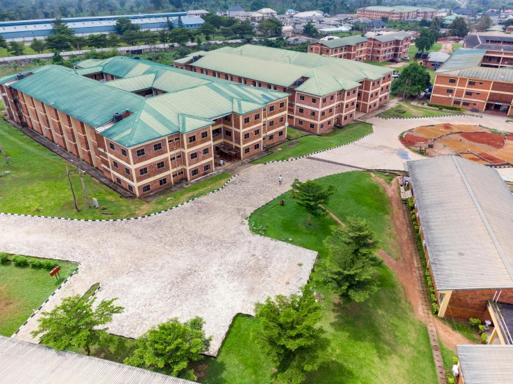 an aerial s of an apartment building, and one of the buildings is surrounded by lush green grass