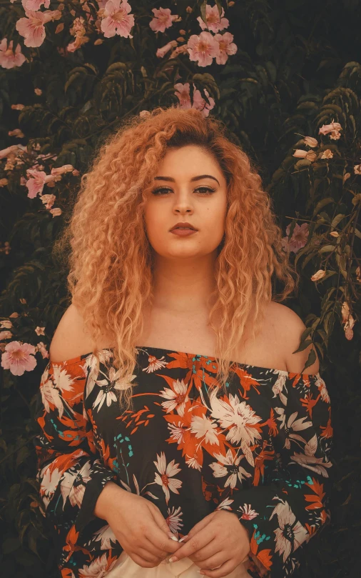 a woman wearing an off the shoulder floral top