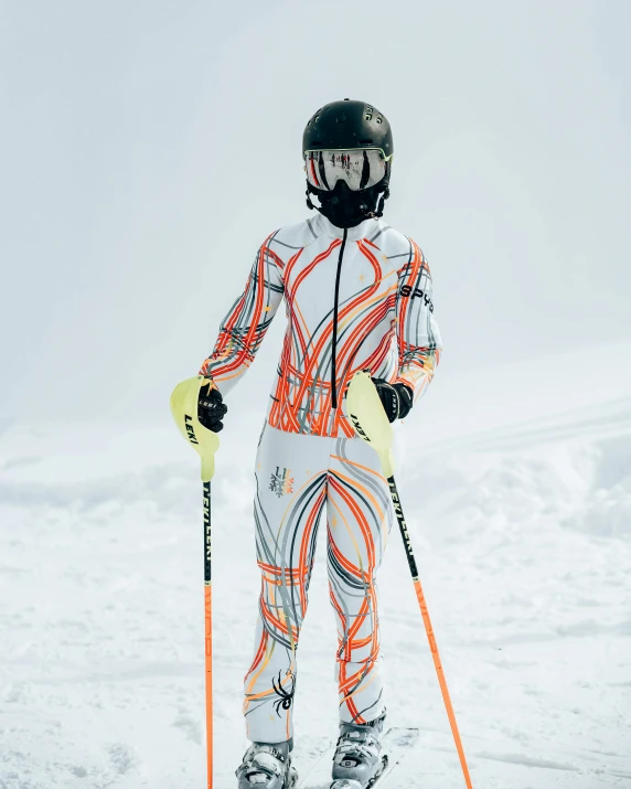 a person is standing on the snowy hill holding skis