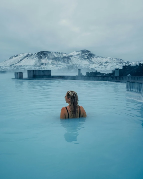 a person swimming in an indoor swimming pool