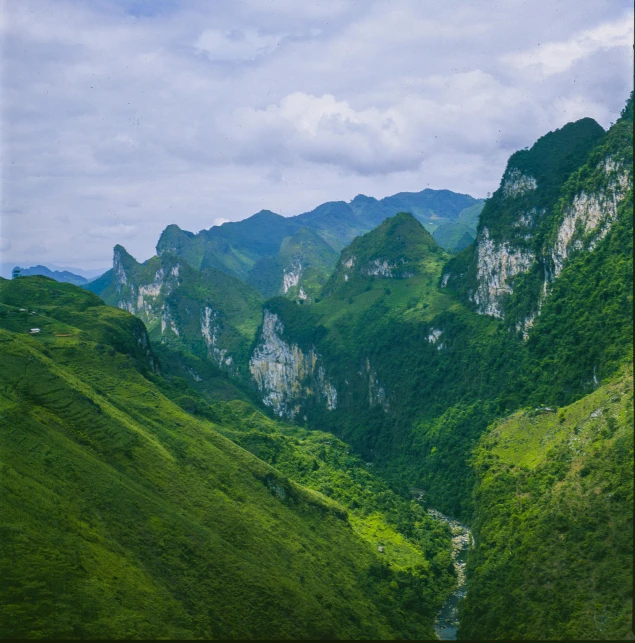 a mountain landscape is shown with green grass and mountains