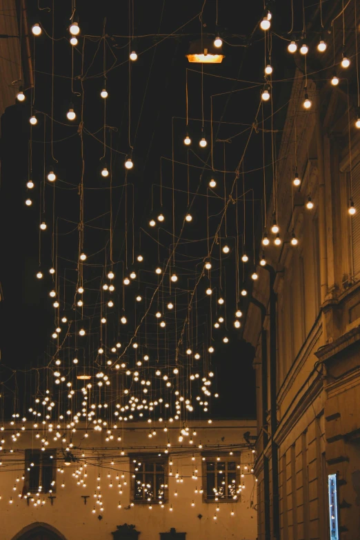 an illuminated structure above a narrow street