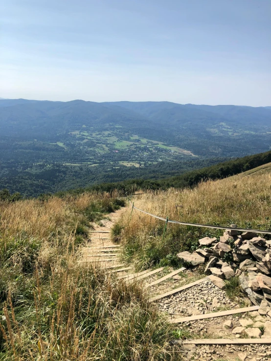 the view from top of a hill, looking out on the valleys in the distance