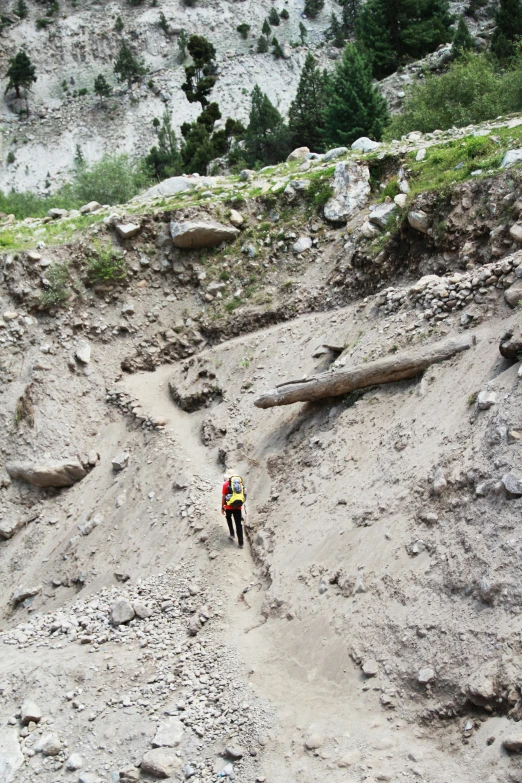 a person hiking on a path that is covered in sand