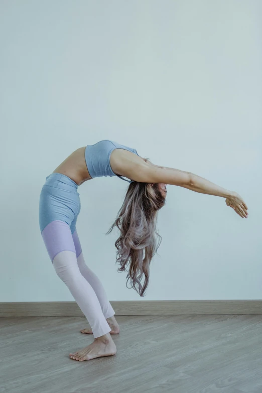 a young woman is doing yoga on the floor