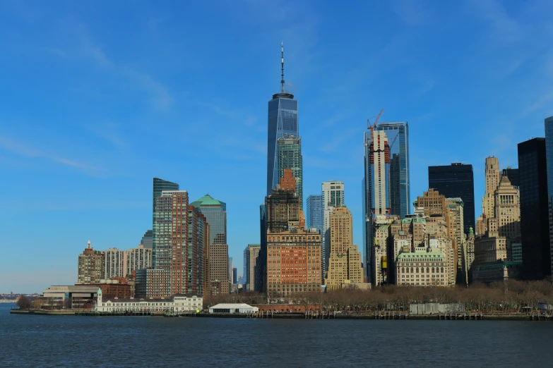 tall skyscrs stand next to each other near the water