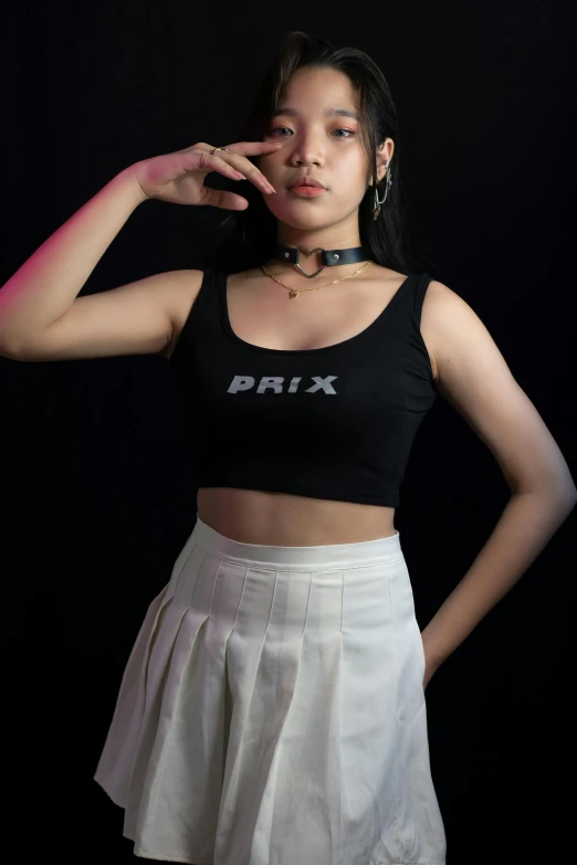 young asian woman posing wearing black top with logo