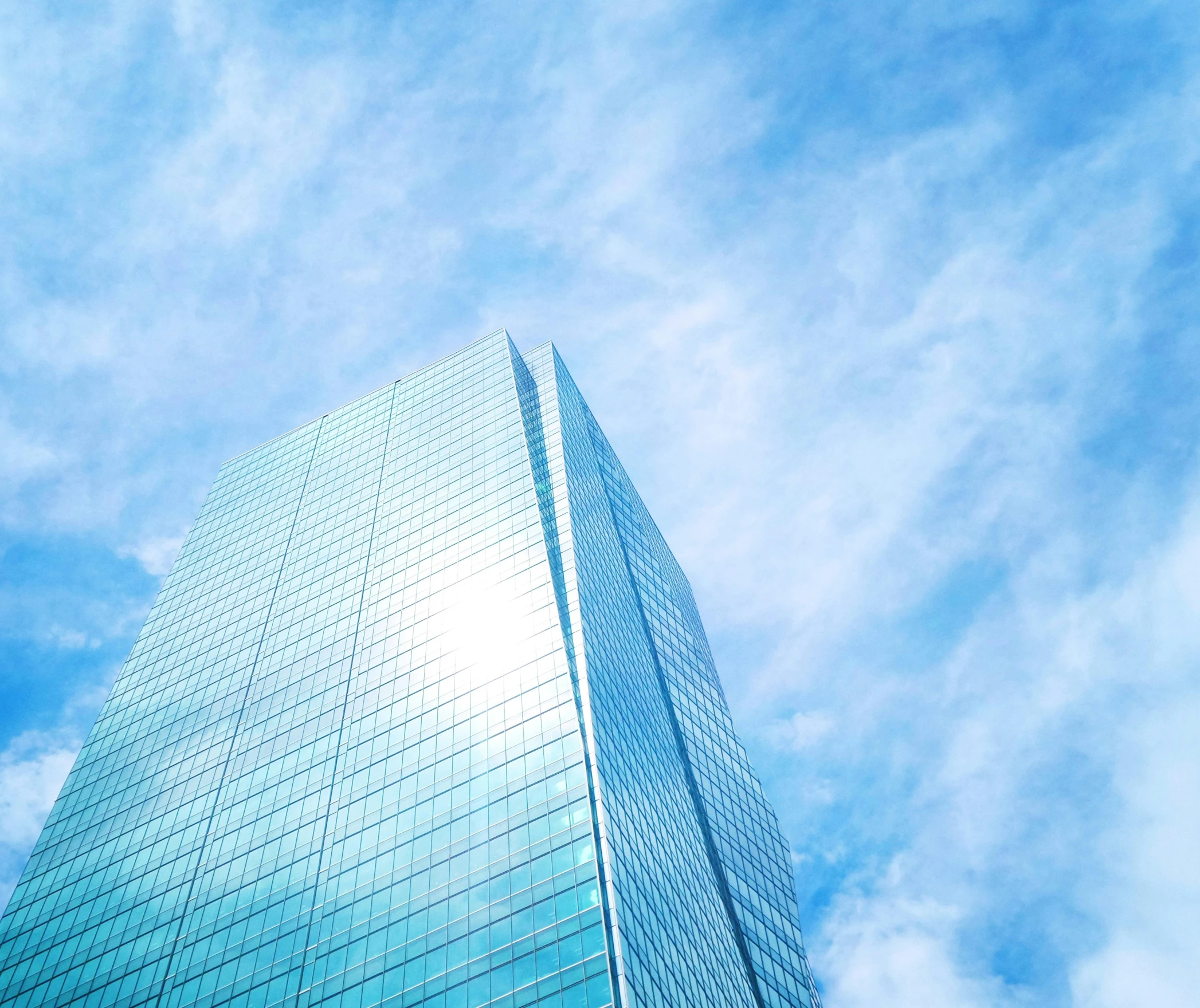 the very large building is against the blue sky