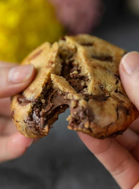 two chocolate chip cookies are split in half