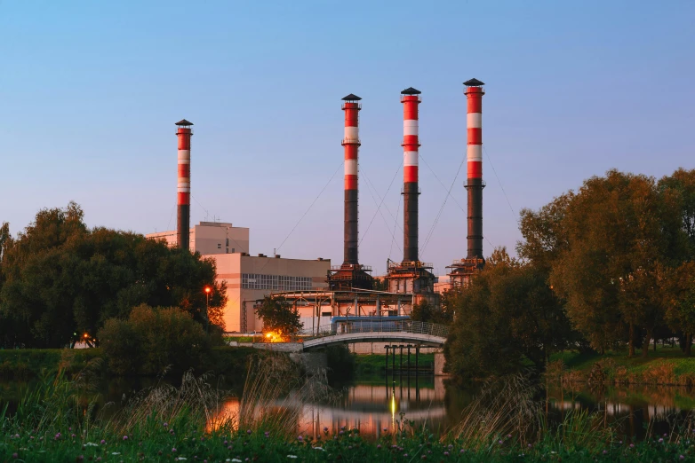 a picture of a factory at the edge of the lake