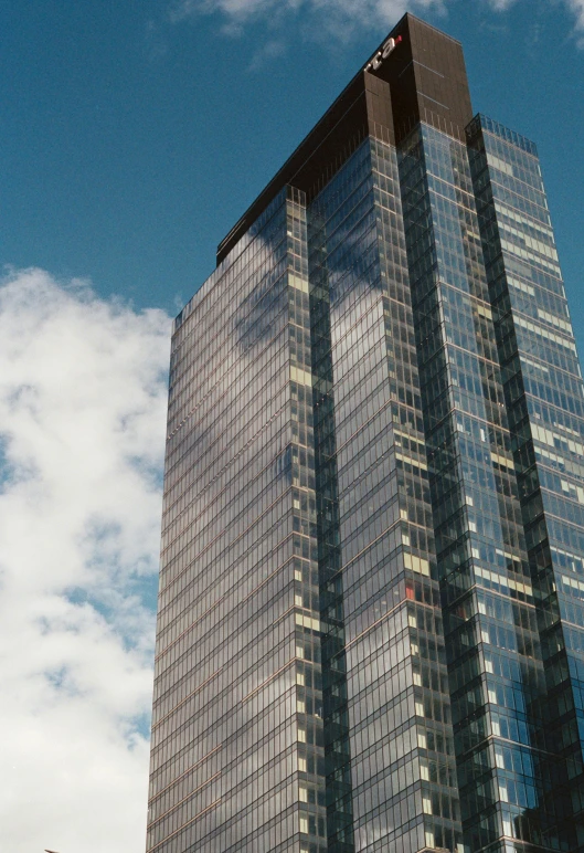 a tall skyscr has glass windows on top