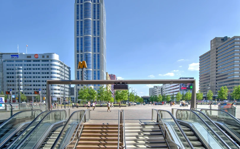 an escalator and some buildings with glass railings