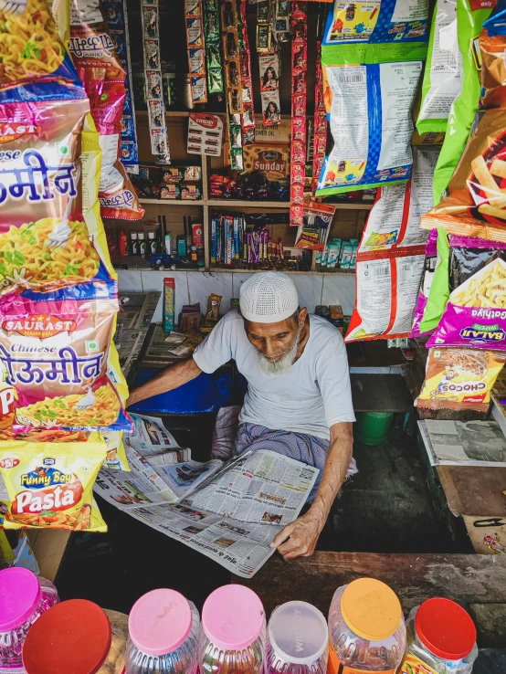 a man that is looking at a newspaper