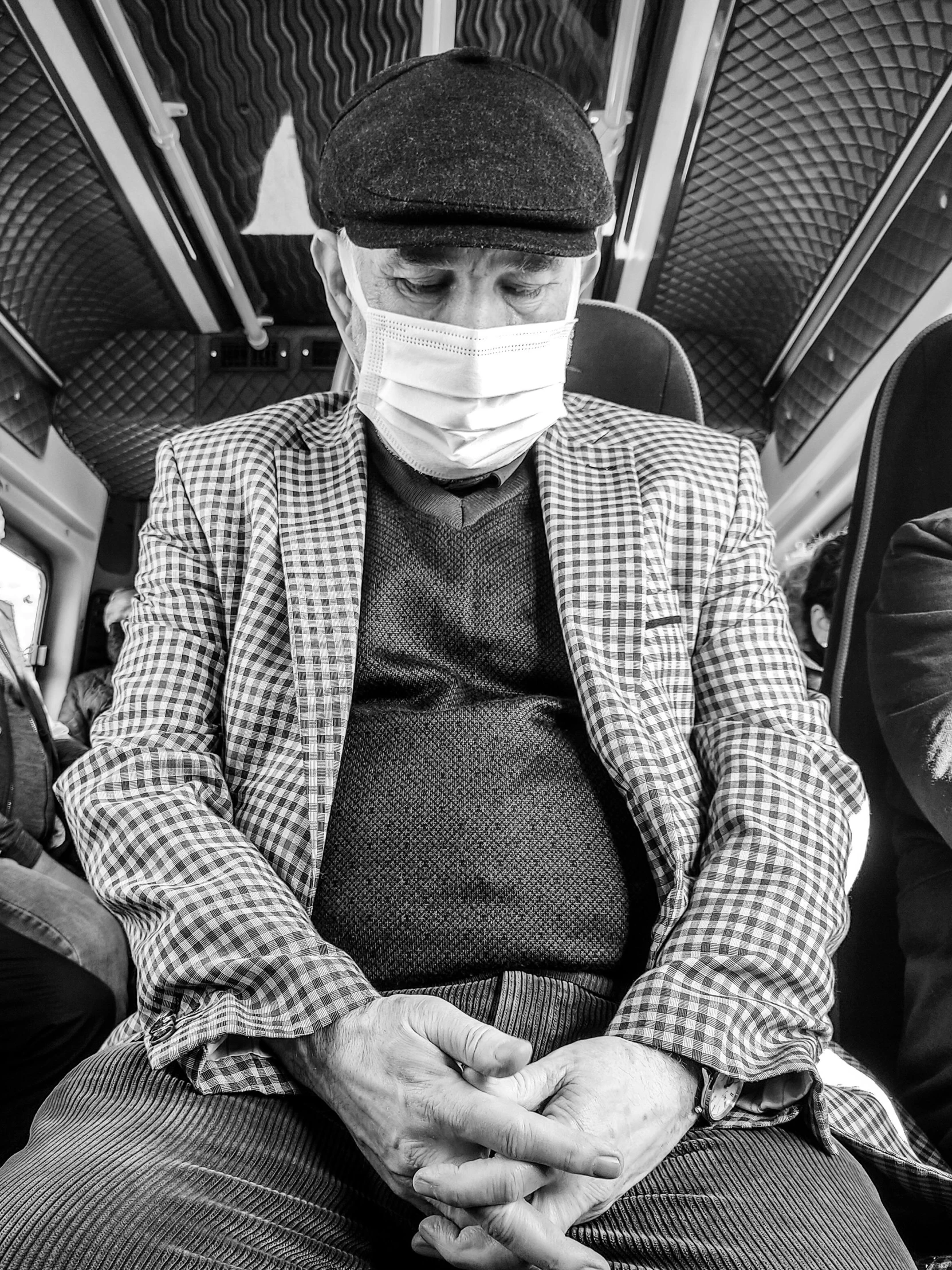 a man with medical gauze sitting in the back of a bus