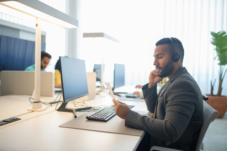 a man with headphones on in an office setting