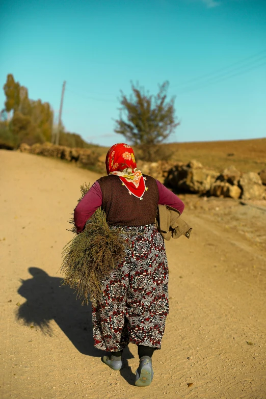 a little  in a red hat and big pants running down the street