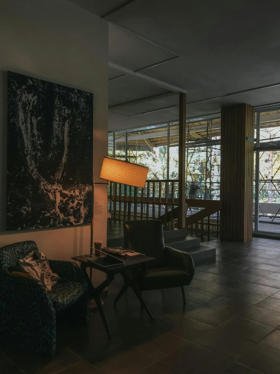 a lamp is lit in a dimly lit lobby area