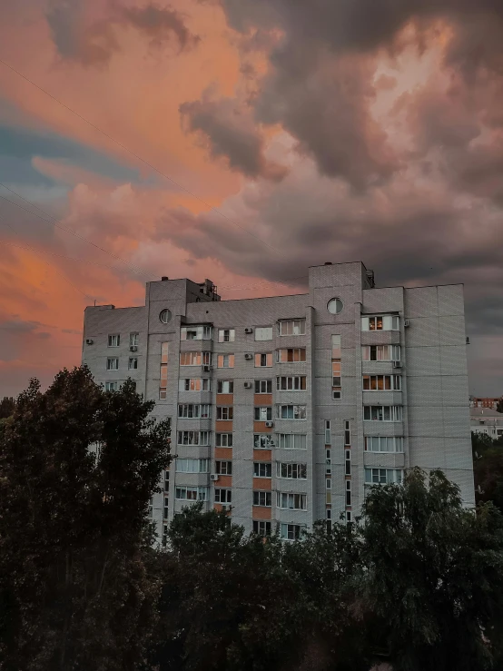 some very pretty tall buildings under a cloudy sky