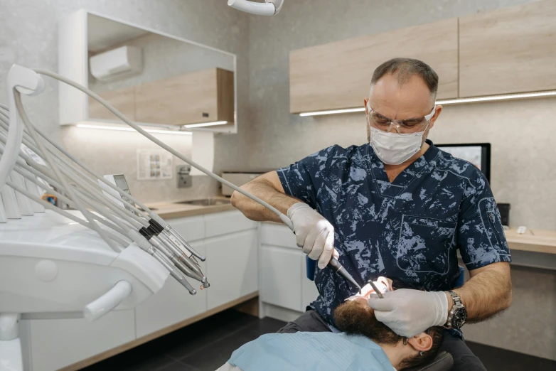 a dentist doing dental checkup on a young man