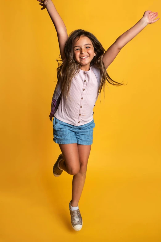 a girl jumping in the air and smiling