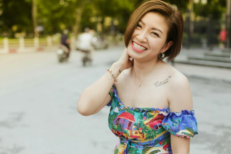 a woman standing on a street with a big smile