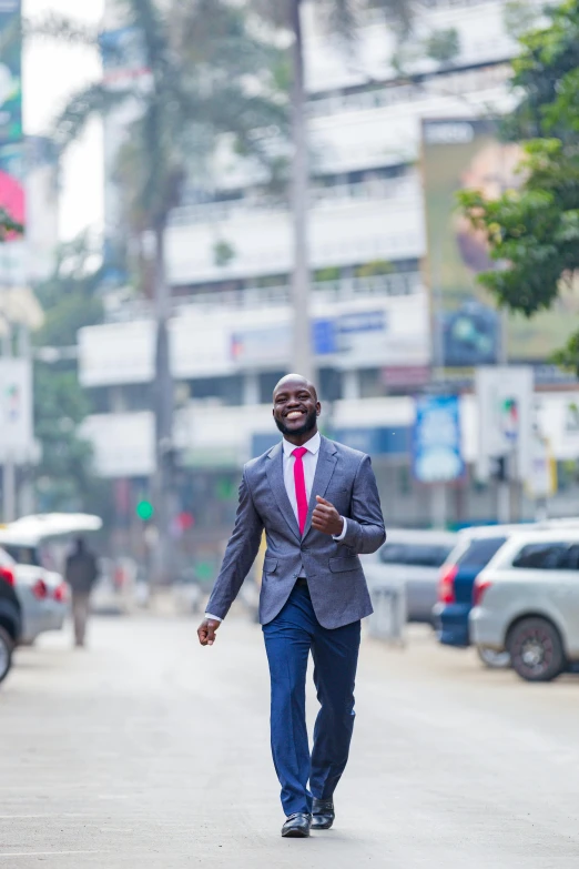 a man walking on a city street in a suit and tie