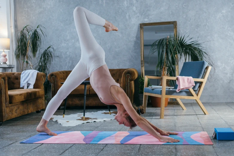 the man is practicing yoga in his living room