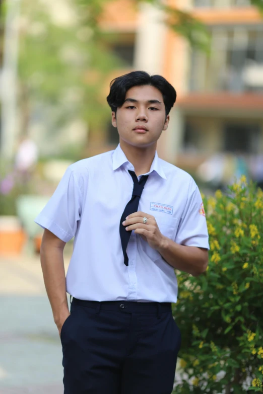 a young man in a short shirt and tie