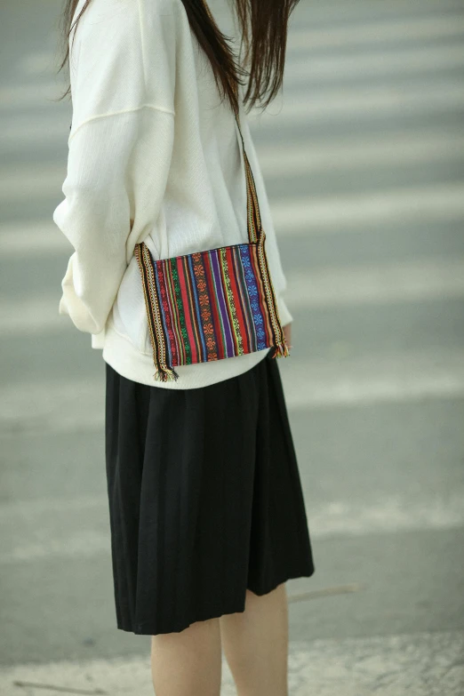 woman in black and white holding her purse