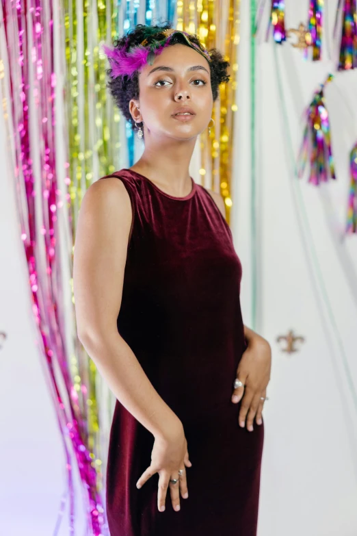 an image of a woman in a dress with an abstract wall behind her