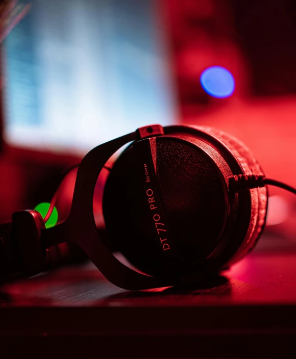 black headphones on the table are bright and red