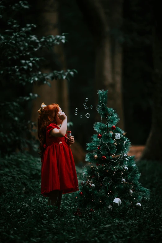 the girl in the red dress is blowing soap bubbles over her face