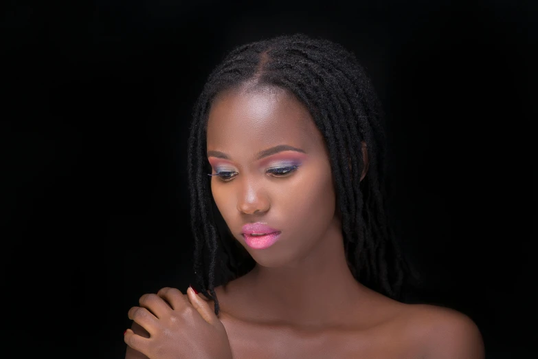 a woman with pink makeup on her face and black skin