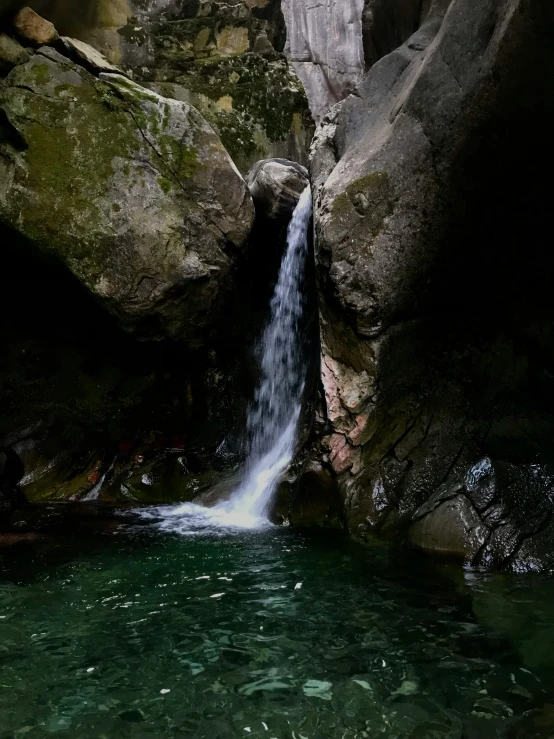 there is a waterfall in the middle of water